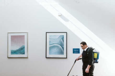 commercial cleaner vacuums art gallery wall